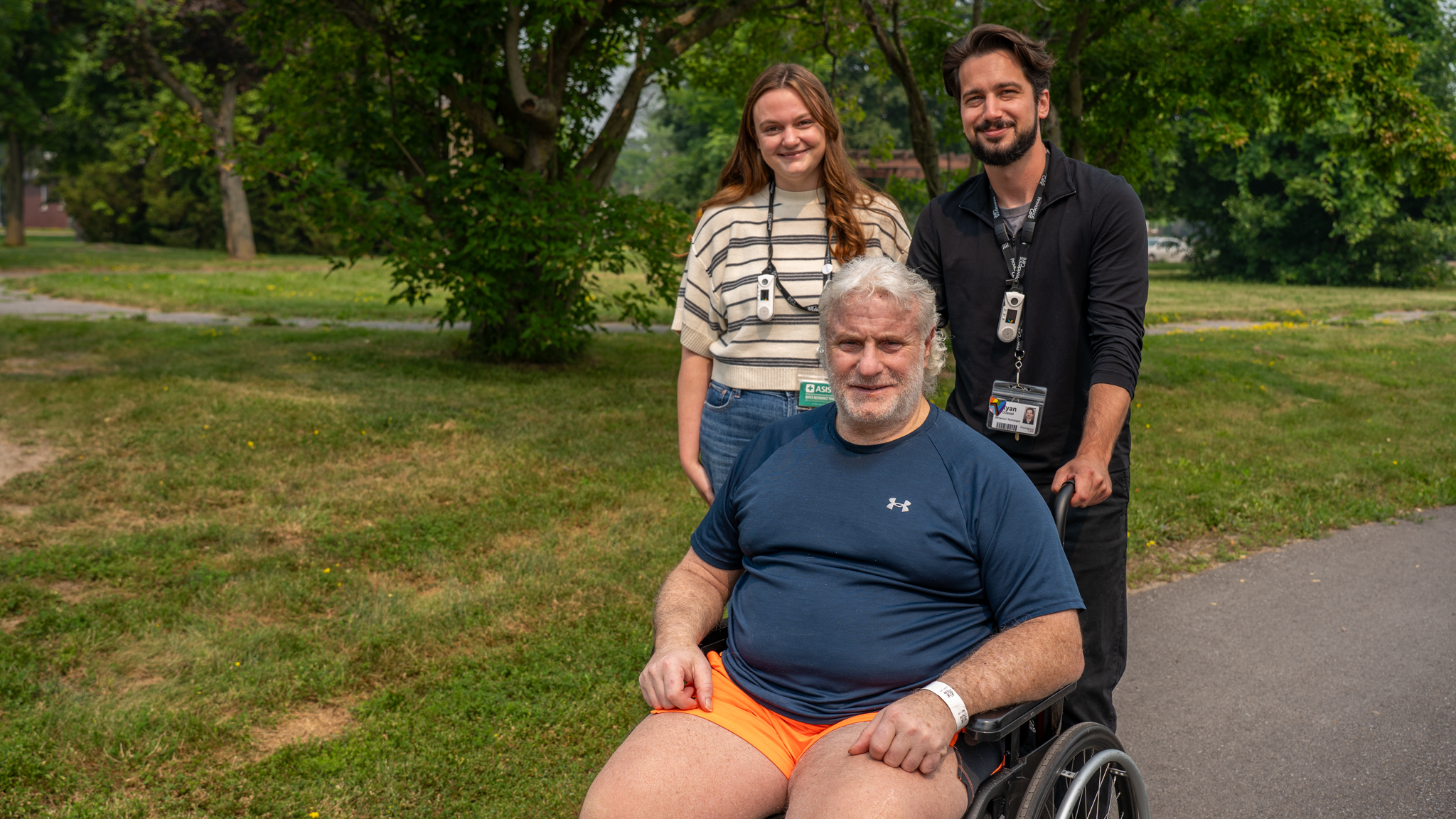 Patient Donato Bracciodieta enjoys a walk outside Providence Transitional Care Centre with Recreation Therapist Hailyne Carr-Williamson and Behaviour Technologist Ryan Dowdall.